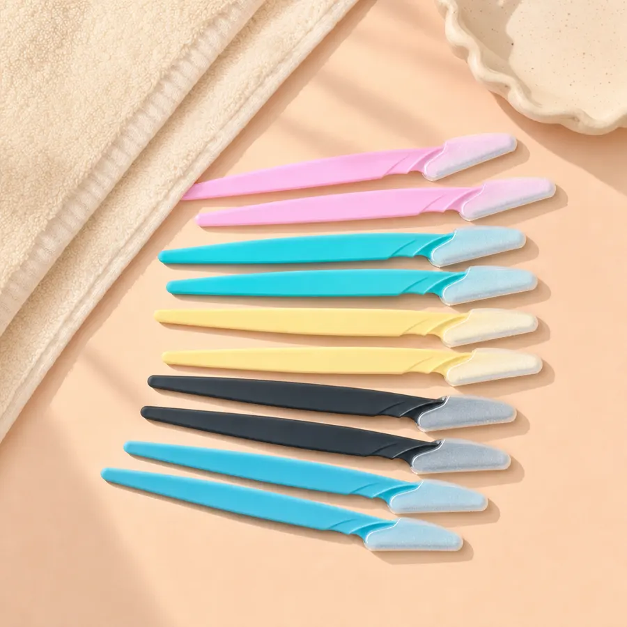 Peachly dermaplane razors styled beside makeup on a soft peach surface